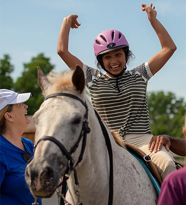 Girl on horse celebrating